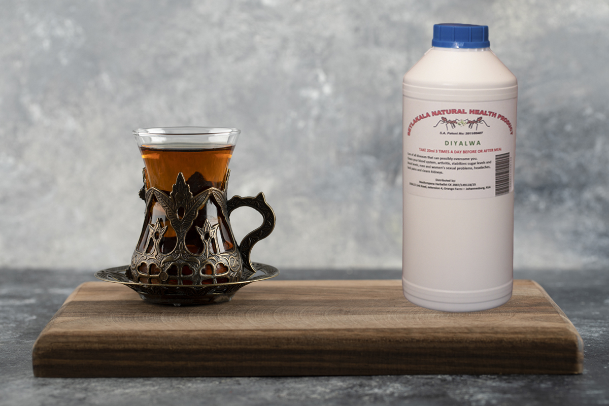 A glass cup of hot tea on a wooden cutting board . High quality photo